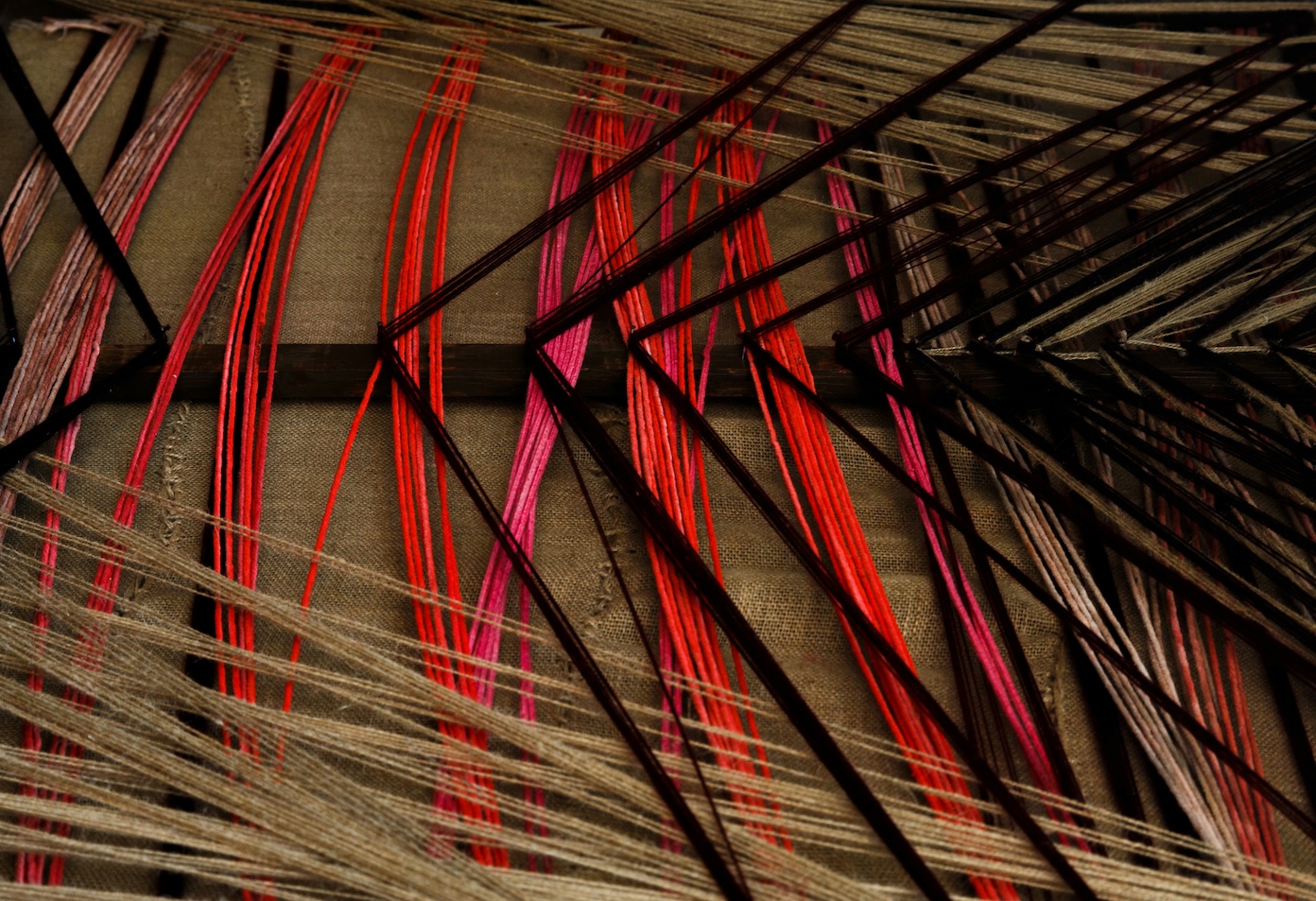 Black and red threads weaving together in chaotic crossing patterns representing the Norse concept of Wyrd and the unconscious patterns that shape our daily lives.